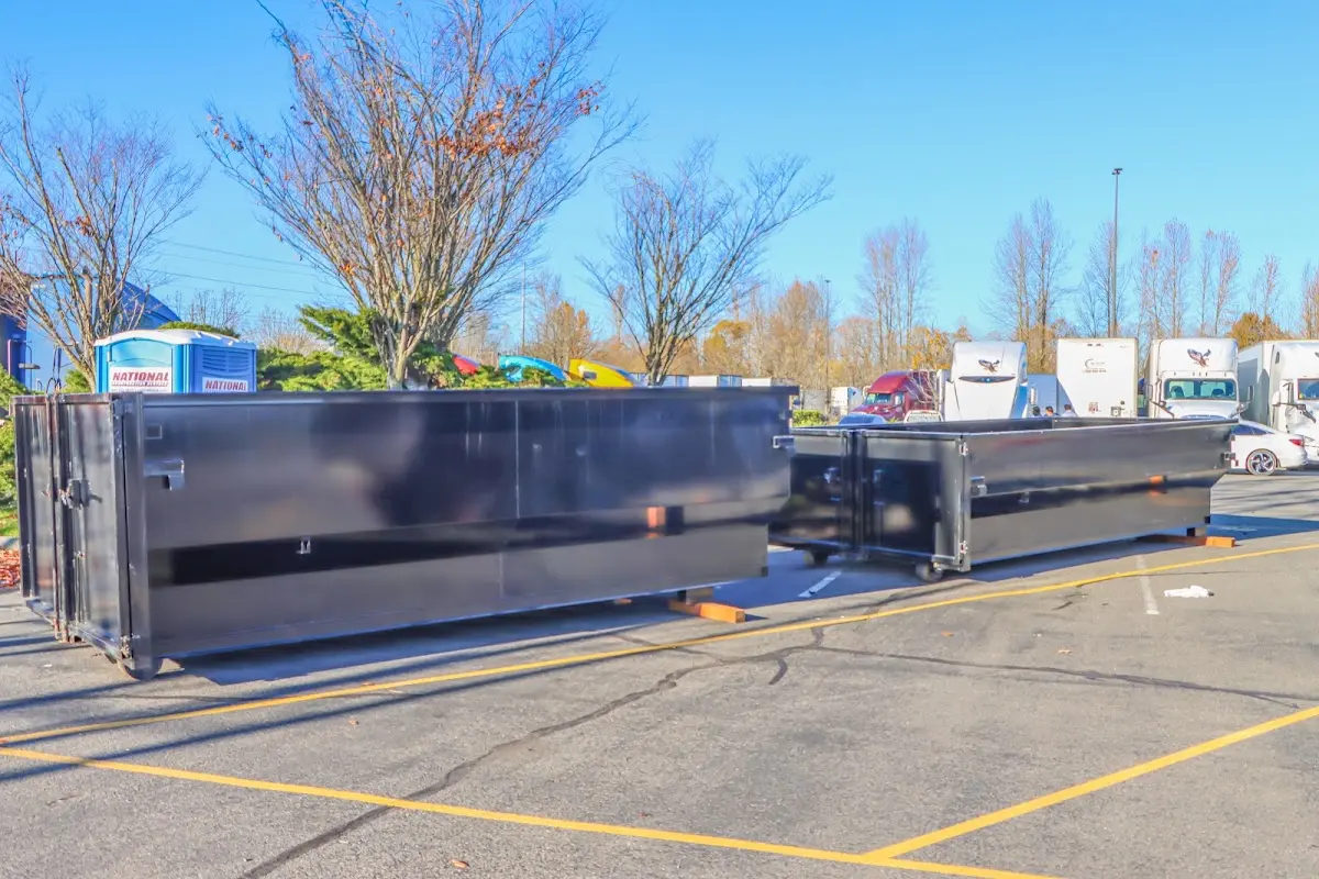 Professional dumpster rental service with roll-off container on residential driveway in Douglass